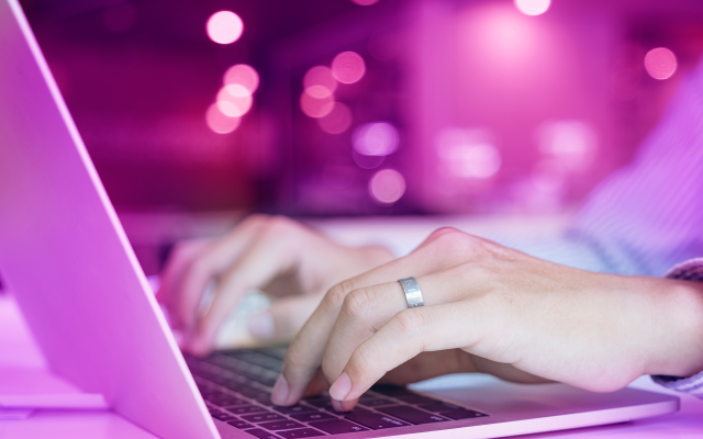 Person typing on laptop - purple wash